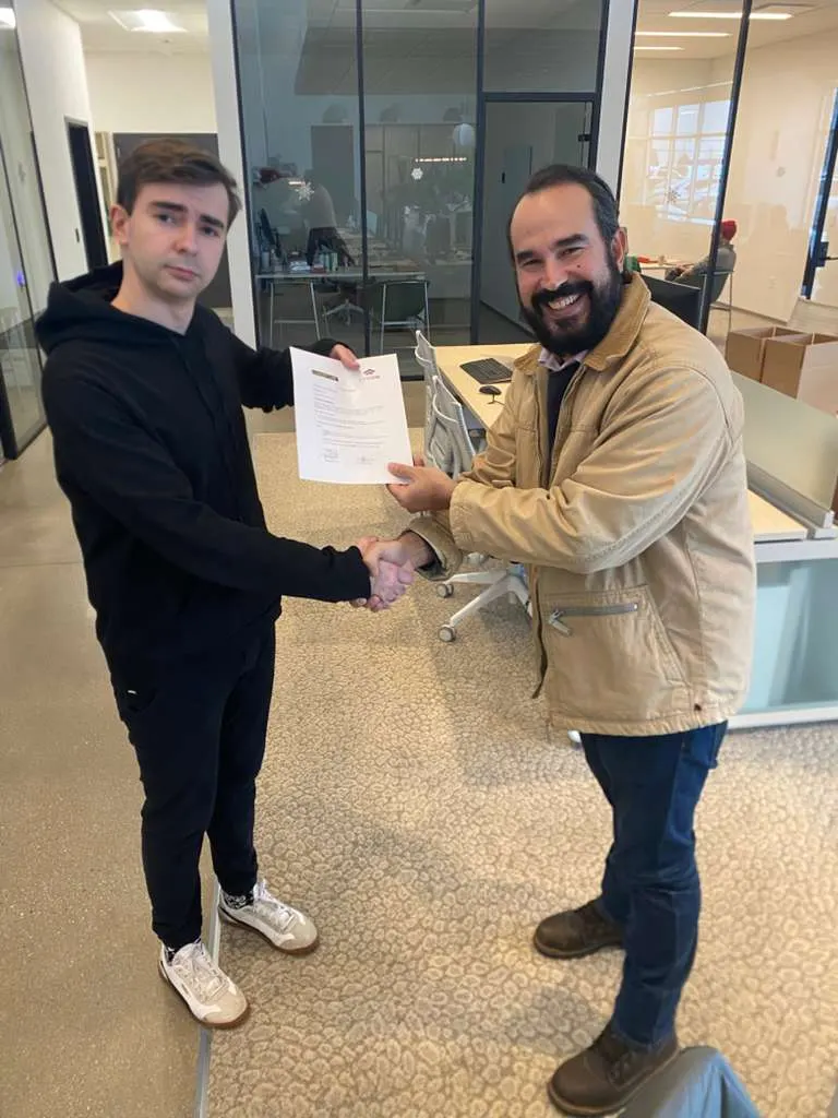 CPCON professionals shaking hands and exchanging a signed project completion document